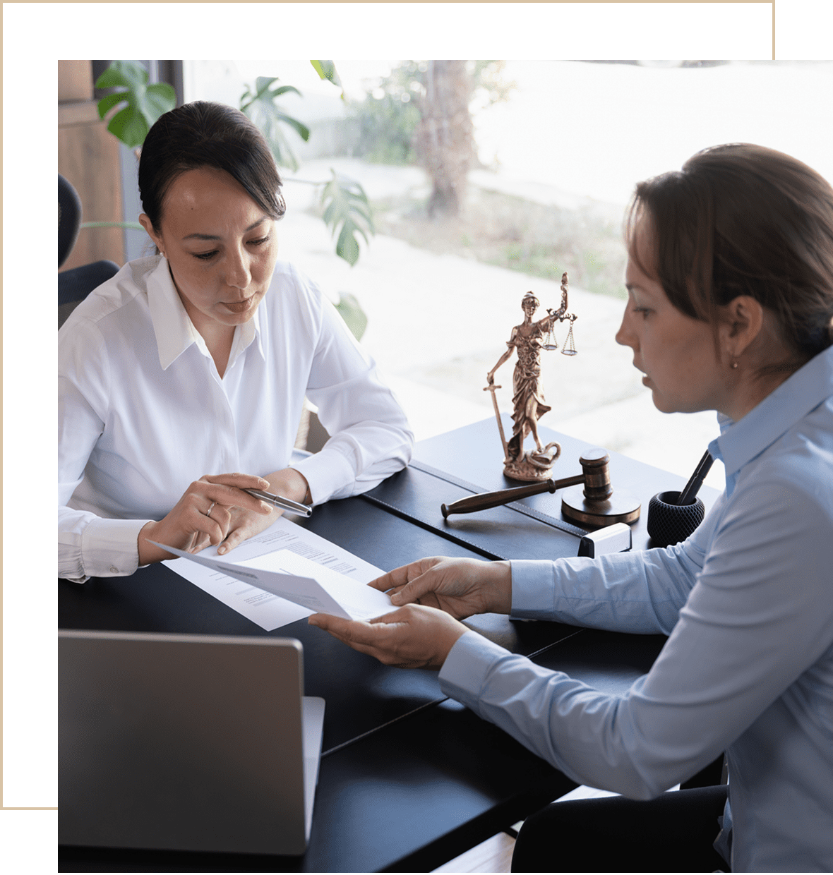 Two women discussing legal documents