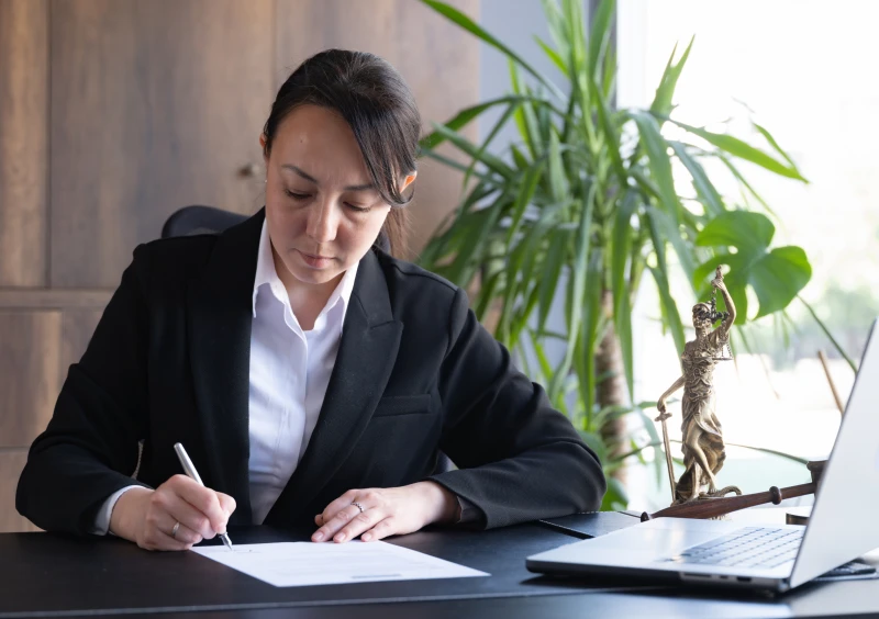Businesswoman working in office with laptop