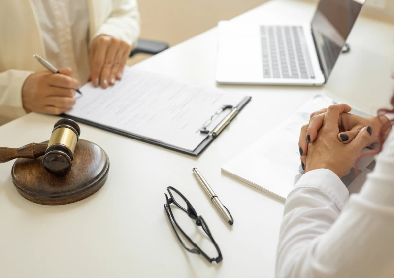 Lawyer meeting with client at desk