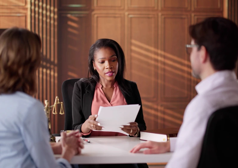 Business meeting with three people at table